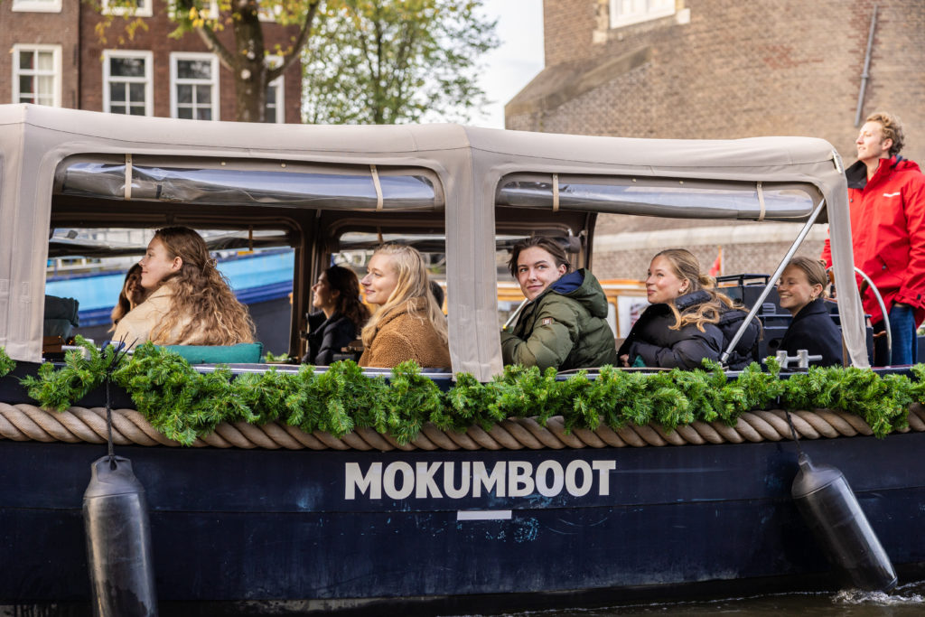 Covered canal boat with Christmas decorations.