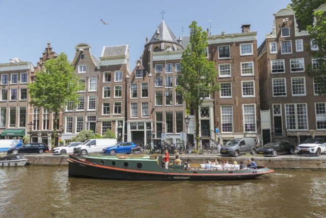 Tugboat cruising past the Magere Brug in Amsterdam